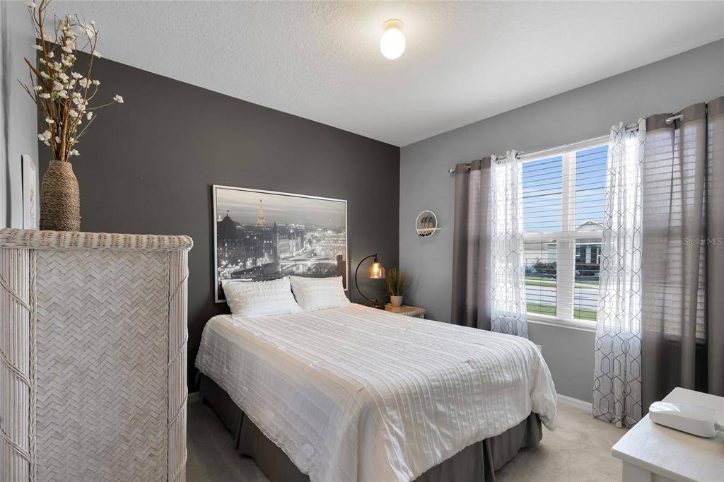 3016 Northeast 43rd Road Ocala, FL 34470 - Photo 17 of 35 a bedroom with a large bed and a window