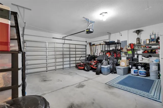 a bedroom with a bed and a flat tv screen on dresser