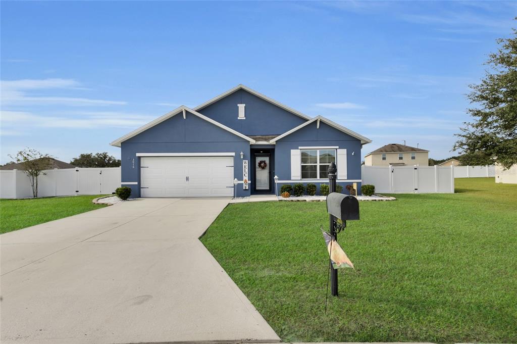 3016 Northeast 43rd Road Ocala, FL 34470 - Photo 2 of 35 a front view of a house with a yard and garage