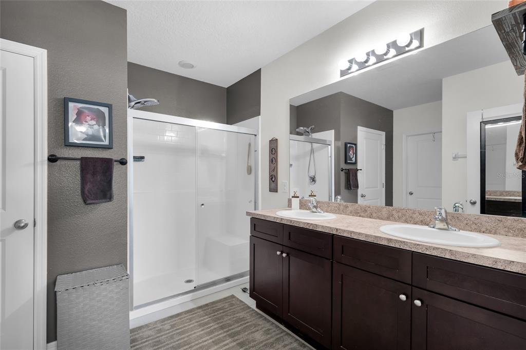 3016 Northeast 43rd Road Ocala, FL 34470 - Photo 22 of 35 a bathroom with a double vanity sink shower and a mirror