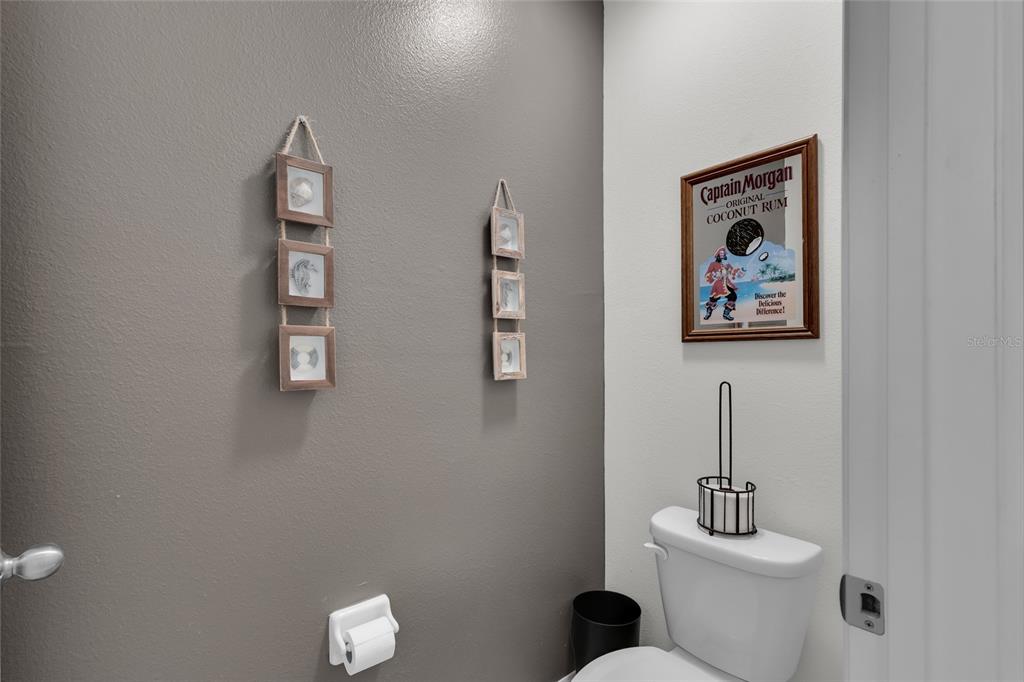 3016 Northeast 43rd Road Ocala, FL 34470 - Photo 23 of 35 a white toilet sitting next to a bathroom sink