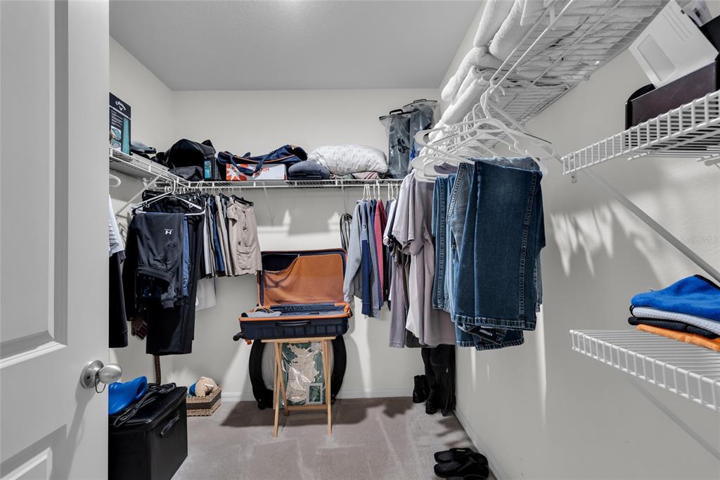 3016 Northeast 43rd Road Ocala, FL 34470 - Photo 24 of 35 a view of walk in closet with clothes and shoes