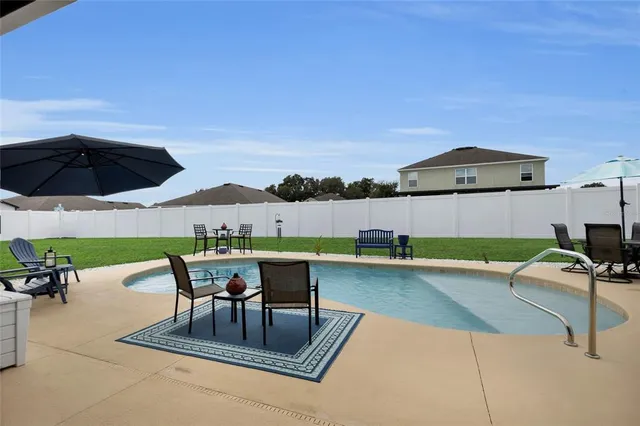 a view of a house with backyard porch and sitting area