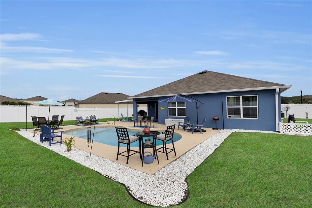 3016 Northeast 43rd Road Ocala, FL 34470 - Photo 30 of 35 a view of a house with patio and a yard