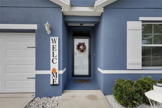 a front view of a house with a potted plant and garage