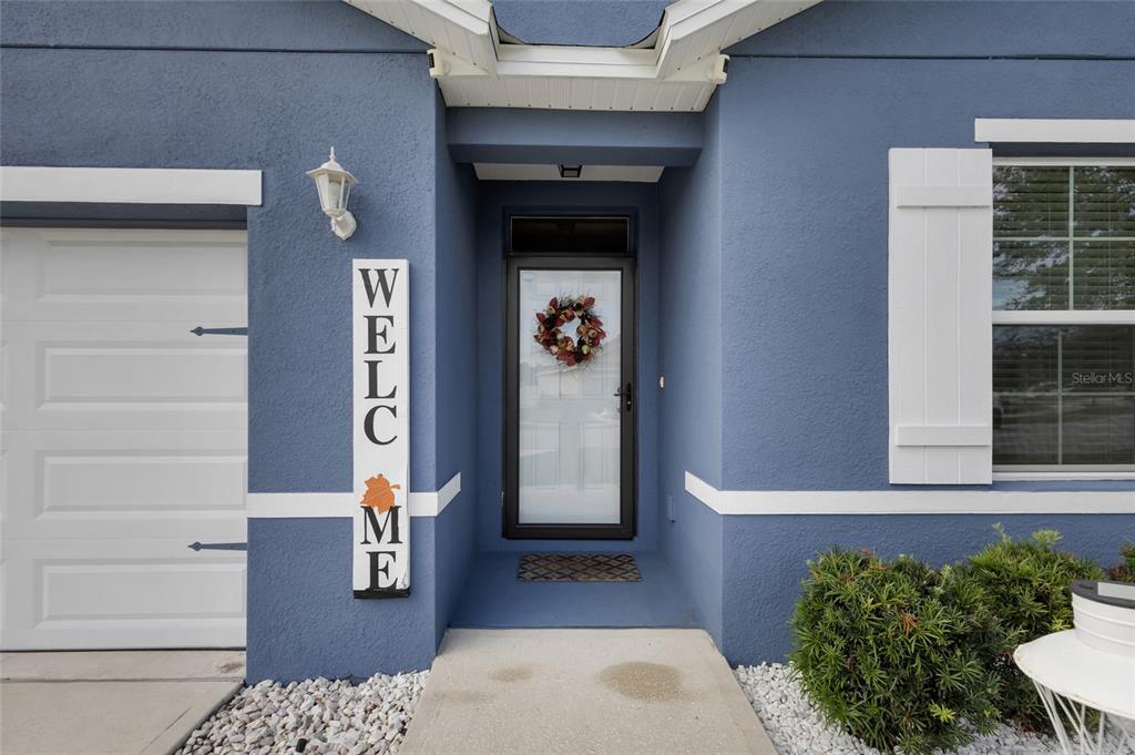 3016 Northeast 43rd Road Ocala, FL 34470 - Photo 5 of 35 a front view of a house with a potted plant and garage