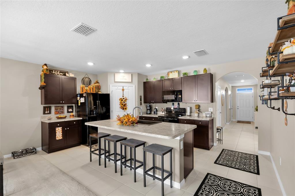3016 Northeast 43rd Road Ocala, FL 34470 - Photo 7 of 35 a kitchen with refrigerator and cabinets