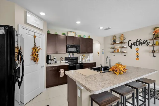 a utility room with lots of clutter and cabinets