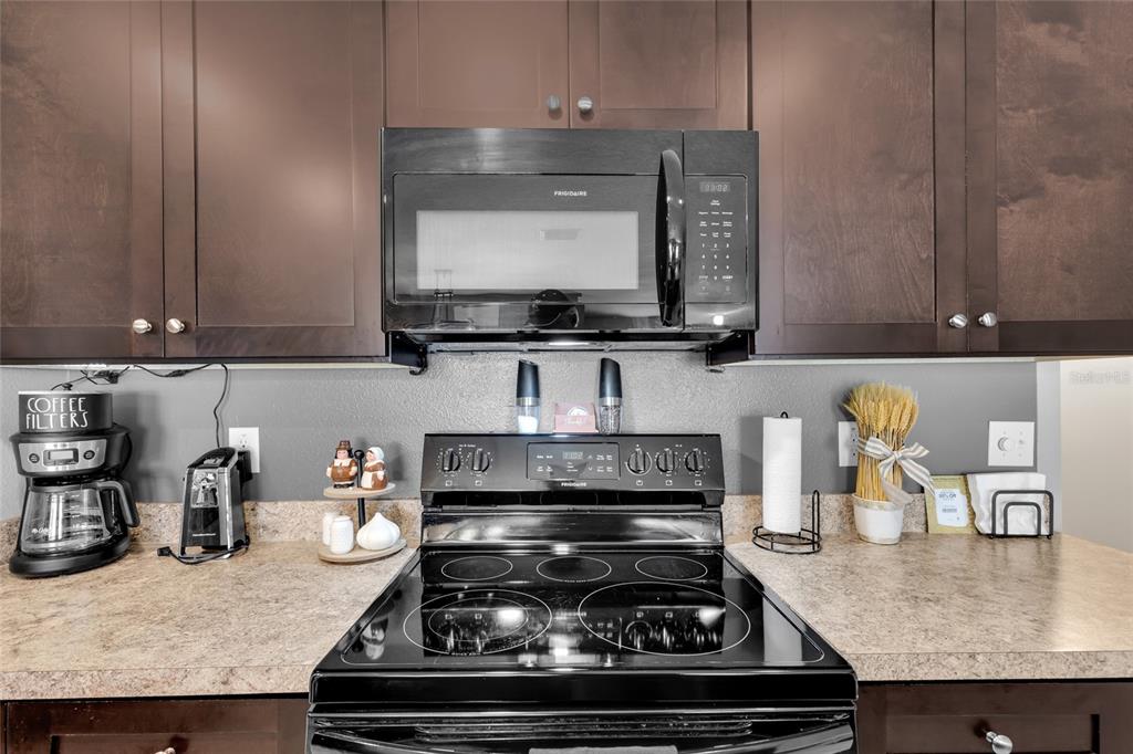 3016 Northeast 43rd Road Ocala, FL 34470 - Photo 10 of 35 a kitchen with a stove and a microwave