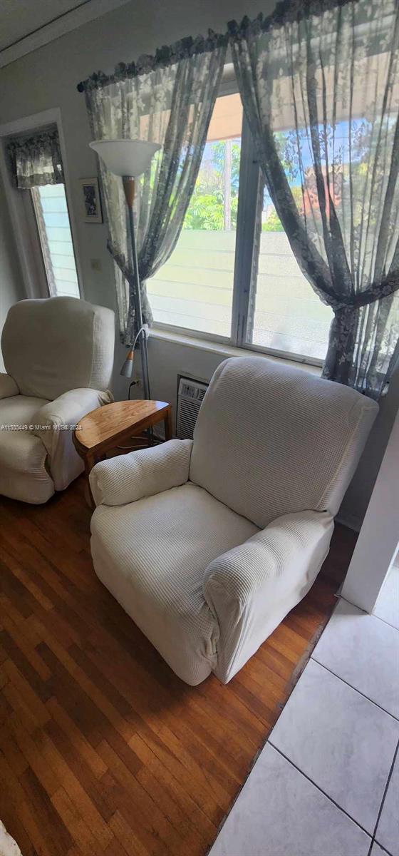 60 Northwest 79th Street, Unit 28 Miami, FL 33150 - Photo 22 of 28 a living room with furniture and a chandelier