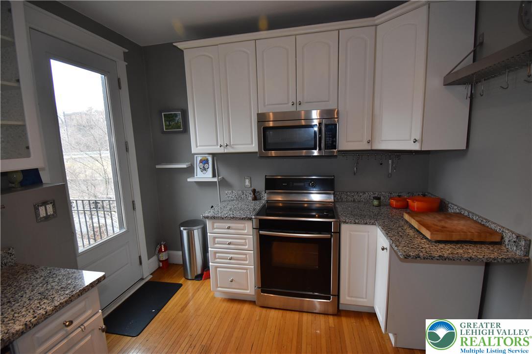 134 North 3rd Street Easton, PA 18042 - Photo 27 of 38 a kitchen with stainless steel appliances granite countertop a stove a sink and a microwave