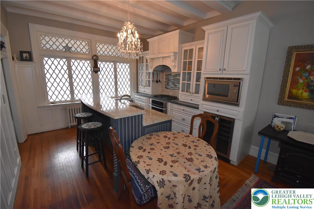 134 North 3rd Street Easton, PA 18042 - Photo 7 of 38 a kitchen with granite countertop a stove a sink a dining table and chairs