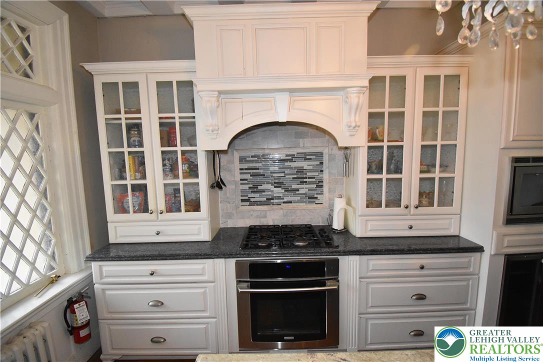 134 North 3rd Street Easton, PA 18042 - Photo 8 of 38 a kitchen with granite countertop white cabinets and appliances