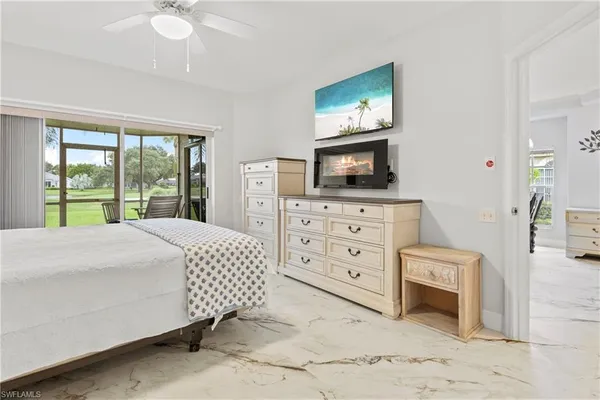 a bedroom with a bed and a television