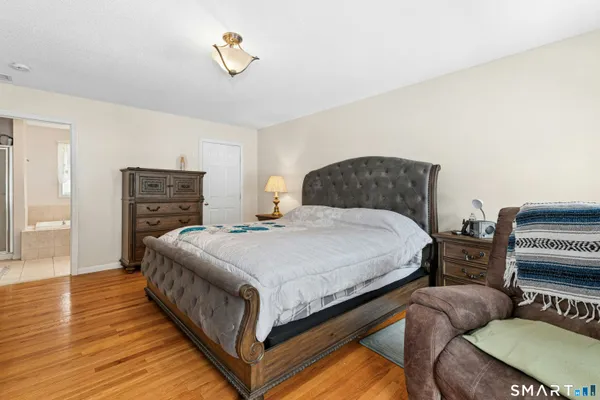 a bedroom with a bed and dresser