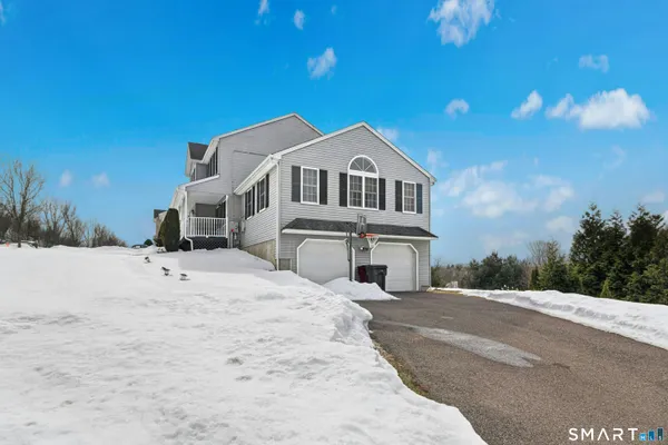 a view of a house with a snow in the yard