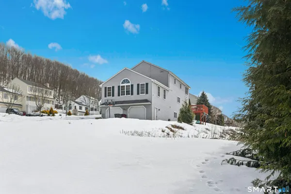 a view of a house with a snow in the background