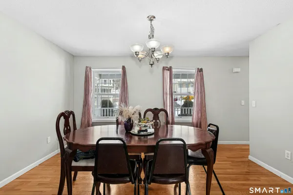 a view of a dining room with furniture and chandelier