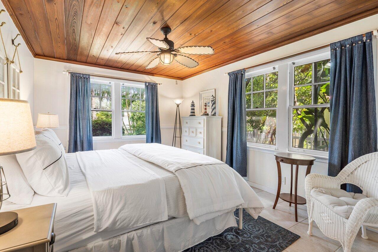 102 Southeast 7th Avenue, Unit VILLA 1 Delray Beach, FL 33483 - Photo 16 of 27 a bedroom with a large bed and a large window