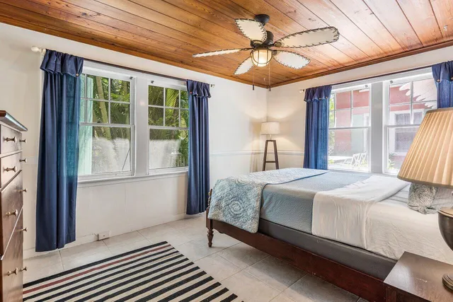 a bedroom with a large bed and a large window with outer view