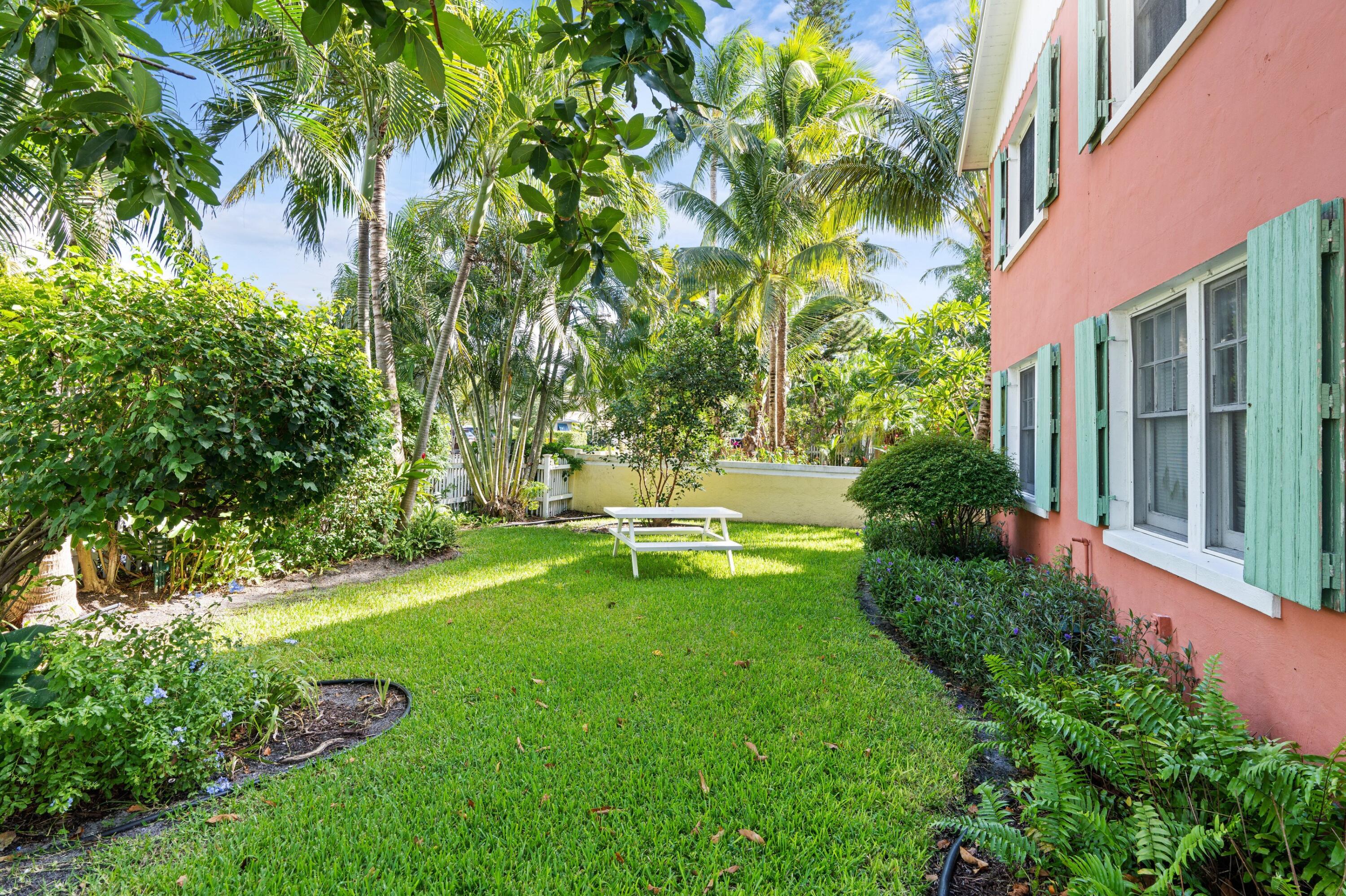 102 Southeast 7th Avenue, Unit VILLA 1 Delray Beach, FL 33483 - Photo 23 of 27 a view of a garden with a bench