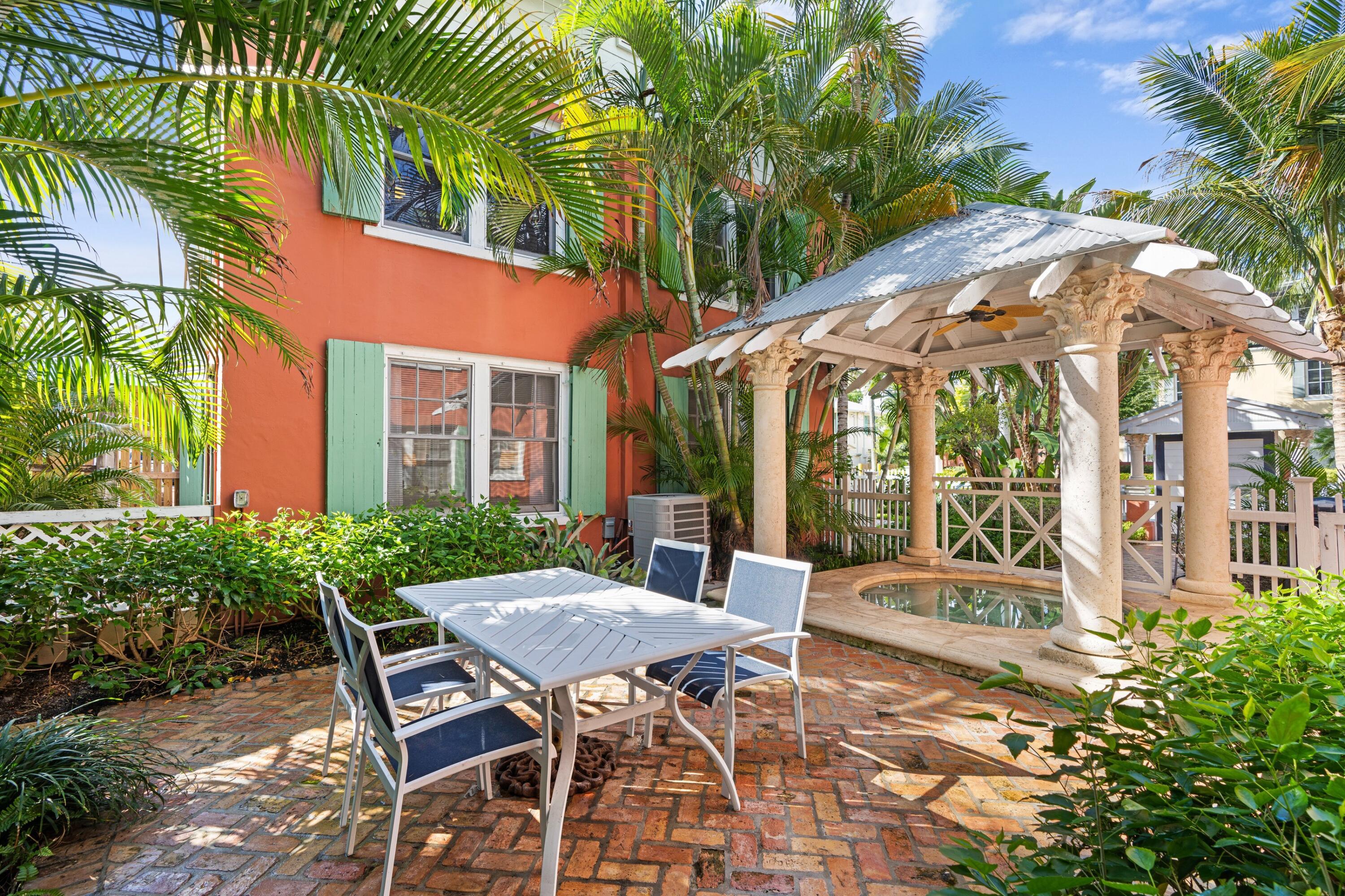102 Southeast 7th Avenue, Unit VILLA 1 Delray Beach, FL 33483 - Photo 6 of 27 a view of a patio with table and chairs and potted plants