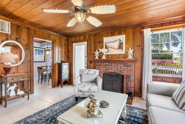 a living room with furniture a fireplace and a chandelier