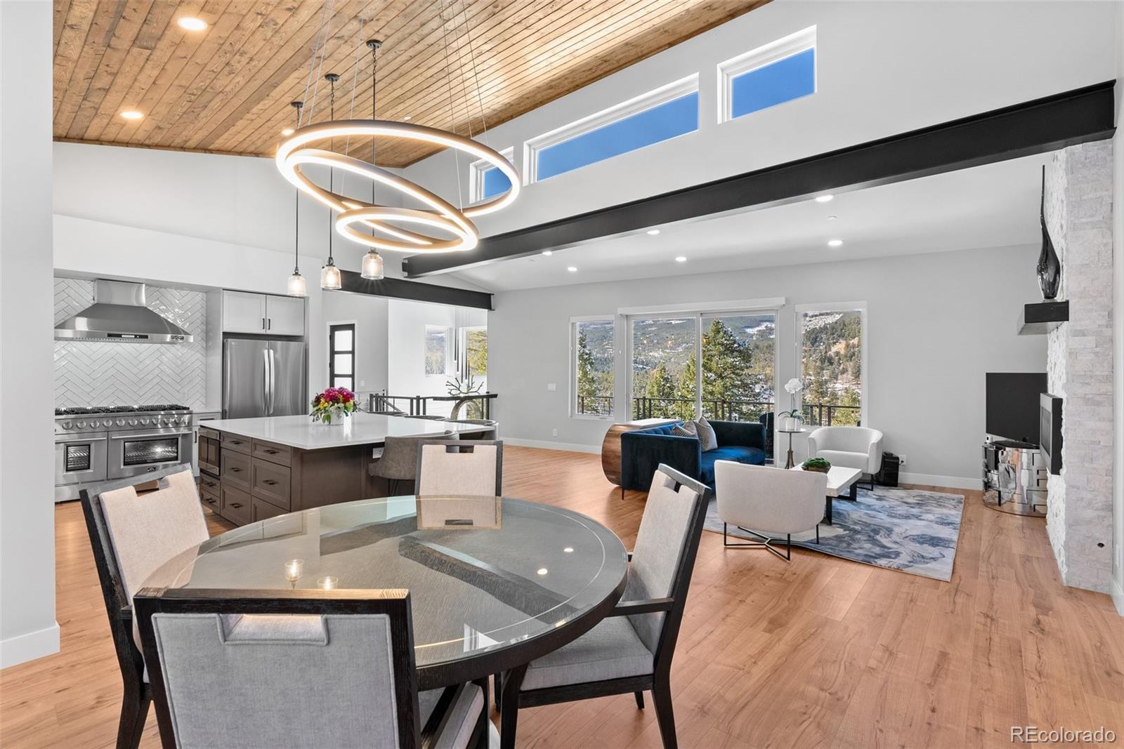 7231 Timber Trail Road Evergreen, CO 80439 - Photo 11 of 34 a view of a dining room with furniture window and wooden floor
