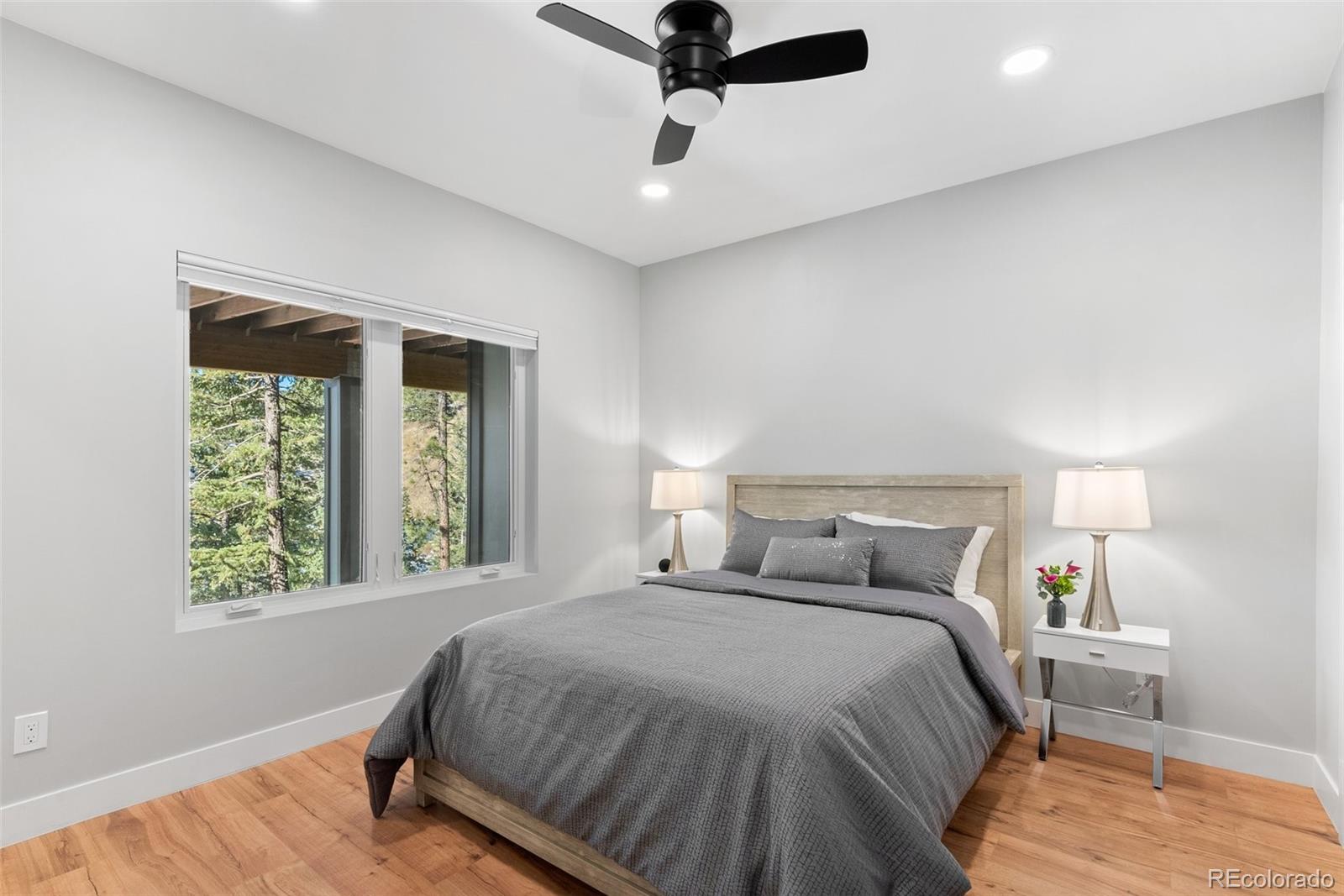 7231 Timber Trail Road Evergreen, CO 80439 - Photo 20 of 34 a bedroom with a bed and window