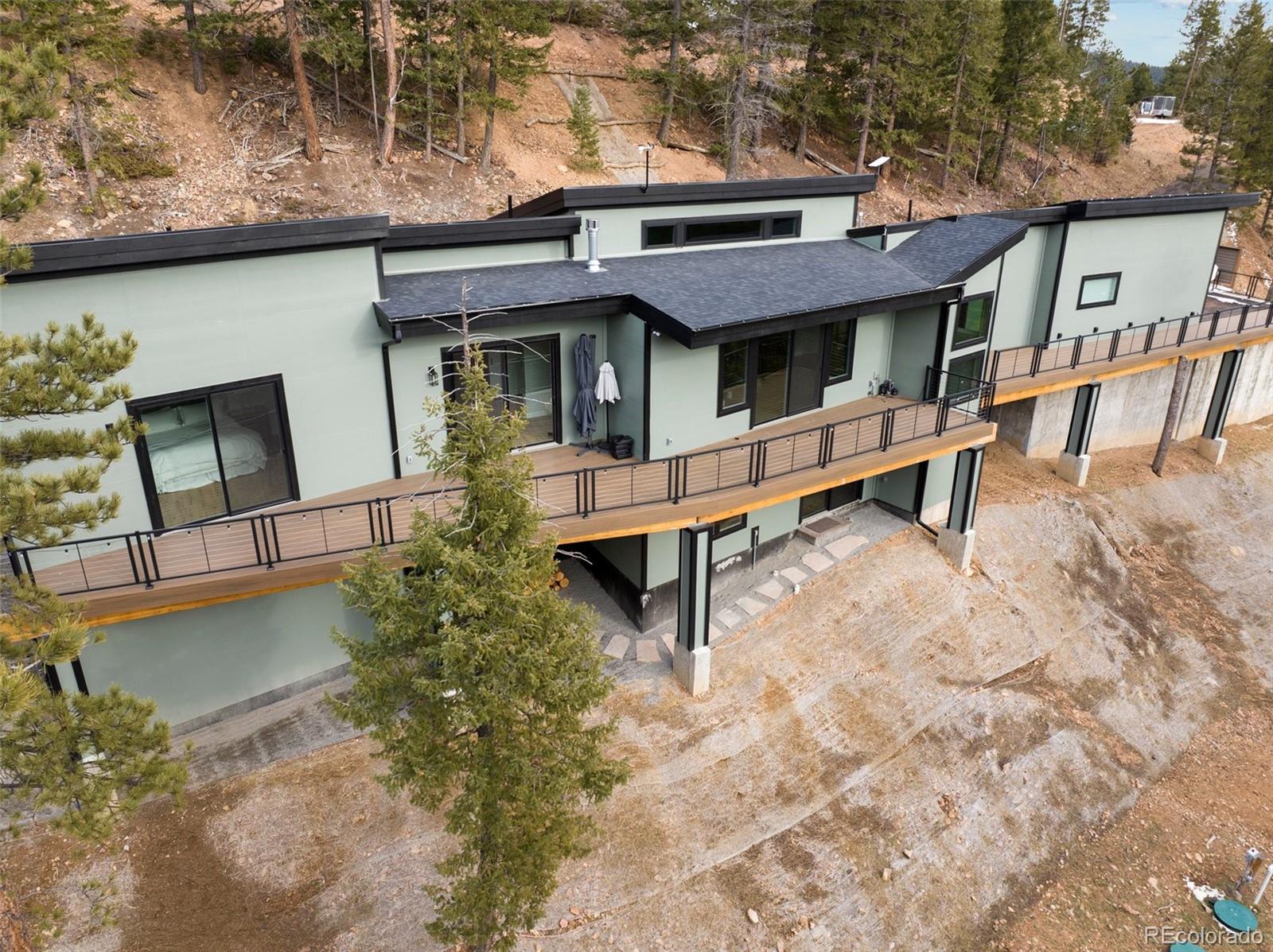 7231 Timber Trail Road Evergreen, CO 80439 - Photo 2 of 34 a front view of a house with garden