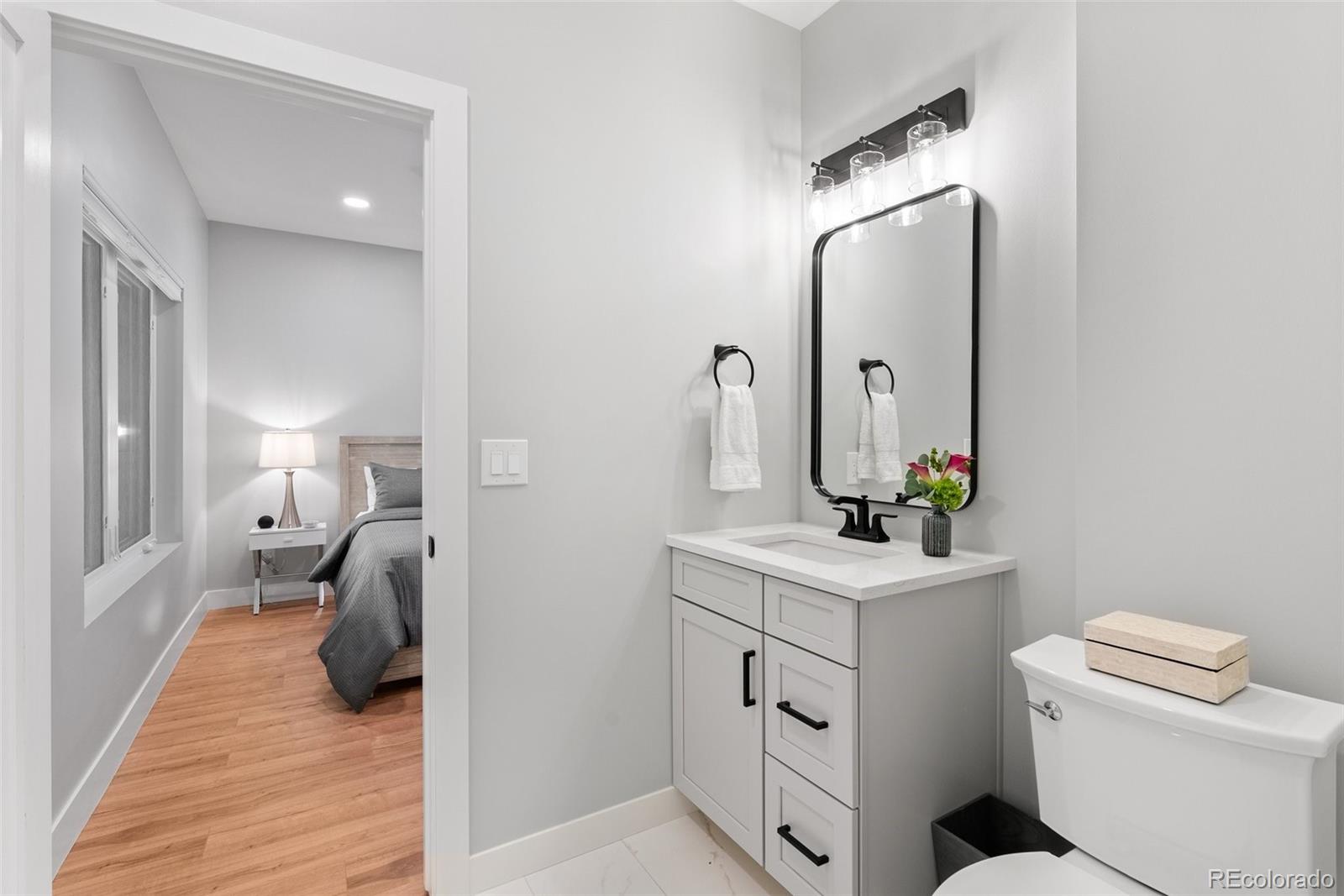 7231 Timber Trail Road Evergreen, CO 80439 - Photo 21 of 34 a en suite bathroom with a toilet sink and mirror