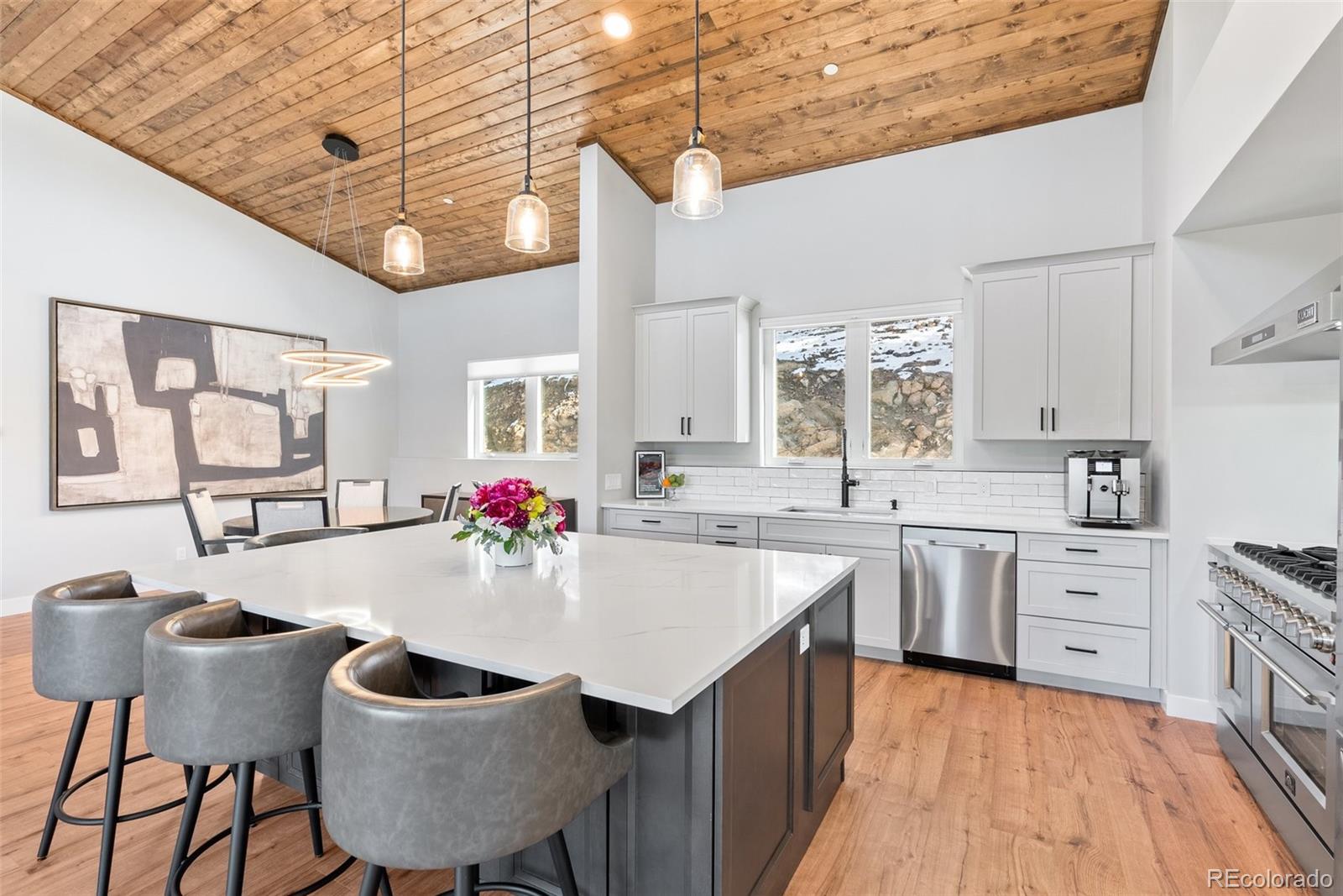 7231 Timber Trail Road Evergreen, CO 80439 - Photo 25 of 34 a large kitchen with kitchen island a sink dining table and chairs