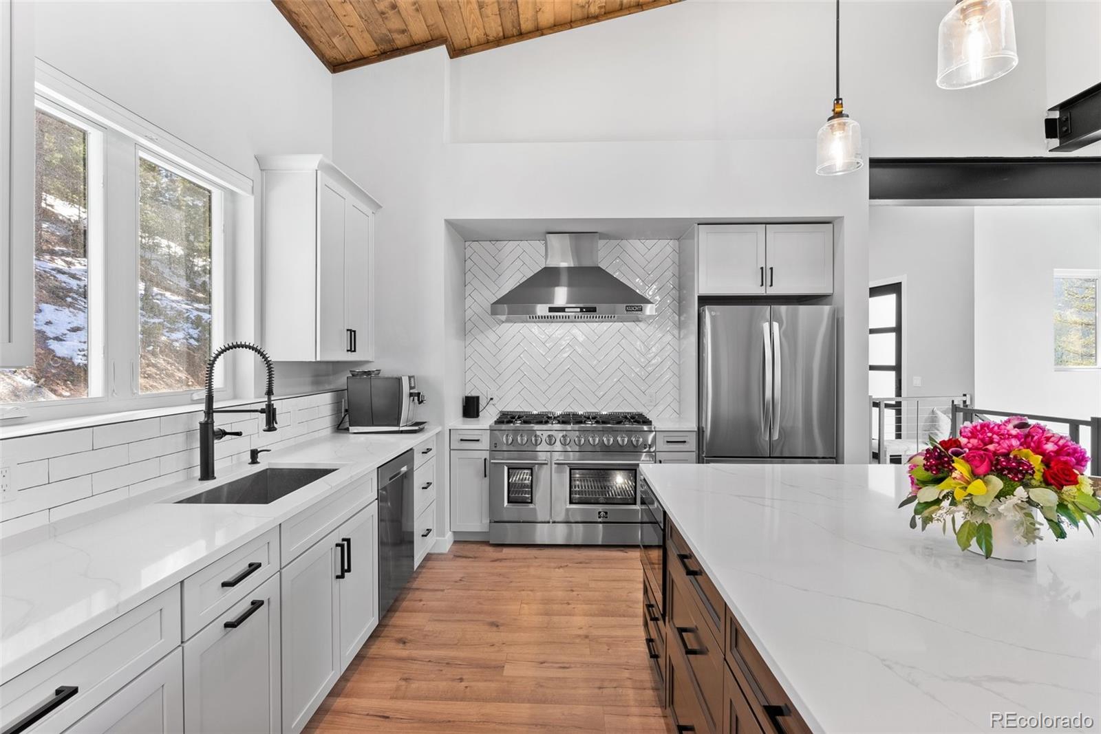 7231 Timber Trail Road Evergreen, CO 80439 - Photo 27 of 34 a kitchen with stainless steel appliances granite countertop a sink stove and refrigerator