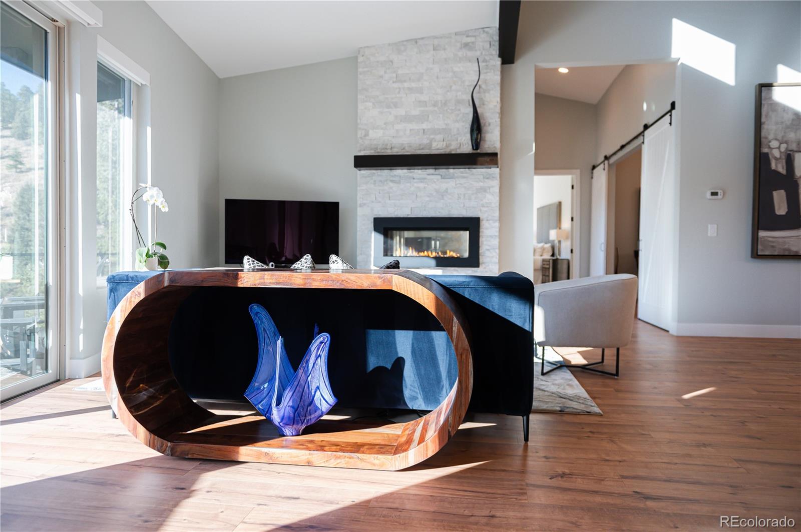 7231 Timber Trail Road Evergreen, CO 80439 - Photo 6 of 34 a bedroom with a bed and wooden floor