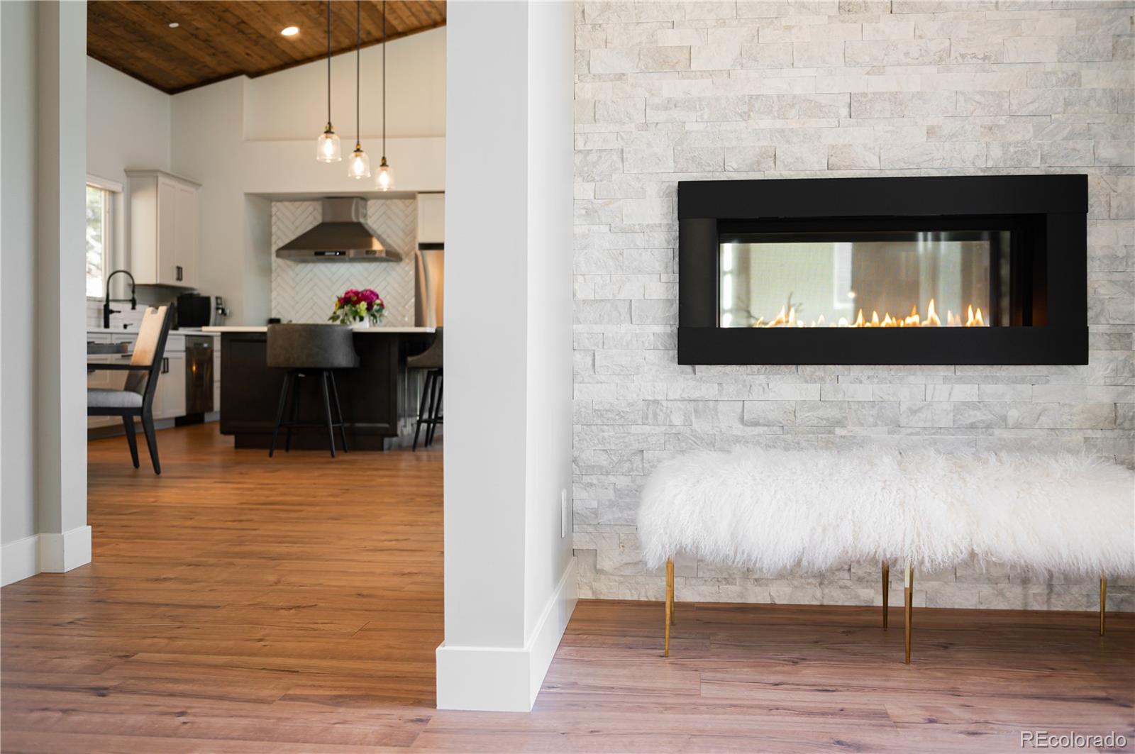 7231 Timber Trail Road Evergreen, CO 80439 - Photo 10 of 34 a living room with furniture and a flat screen tv