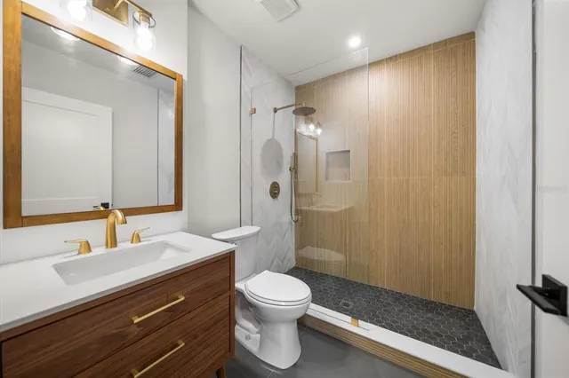 a view of a room with wooden floor bathroom and a sink