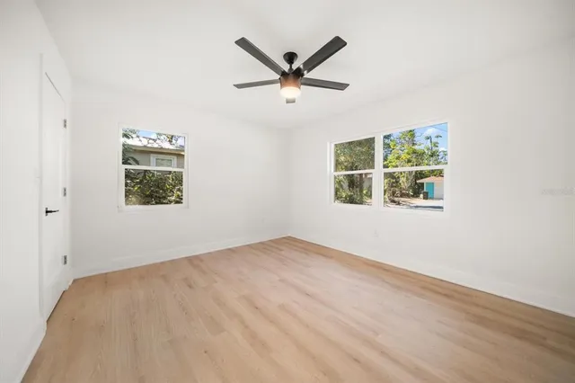 a view of a room with a ceiling fan and a window