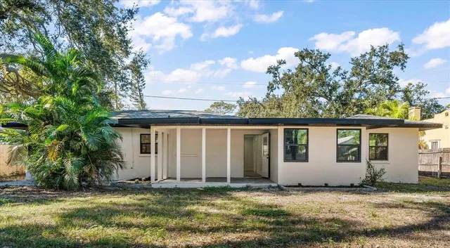 a view of a house with a backyard
