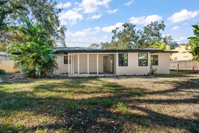 a view of a house with a tree and a yard