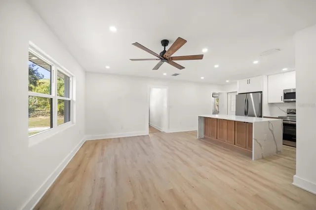 a view of kitchen with wooden floor and window
