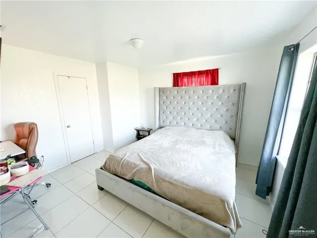 a bedroom with a bed and chair