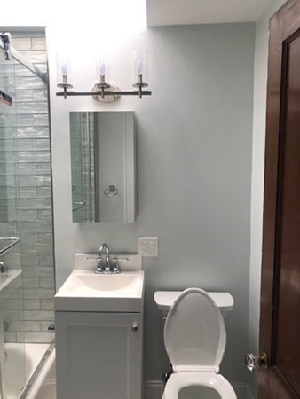 540 Nantasket Avenue, Unit 2 Hull, MA 02045 - Photo 9 of 10 a bathroom with a toilet sink and mirror