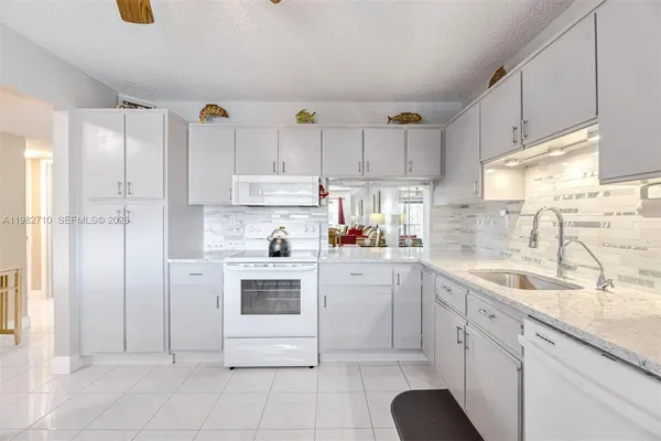 a kitchen with cabinets and window