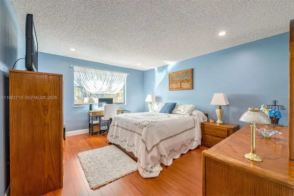 a bedroom with a bed and a painting on the wall