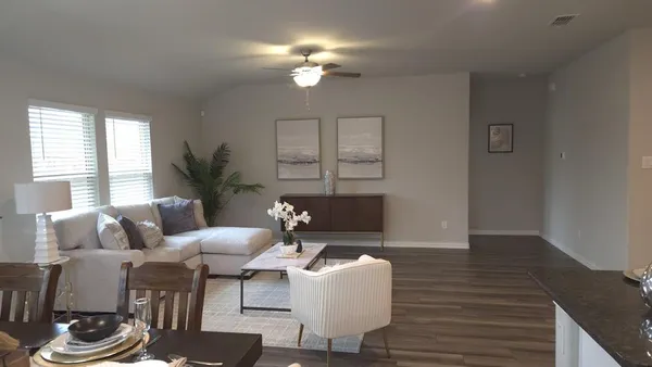 a living room with furniture a chandelier and a window