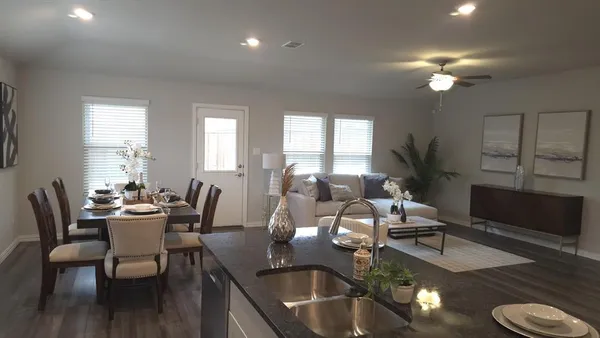 a dining room with furniture and wooden floor