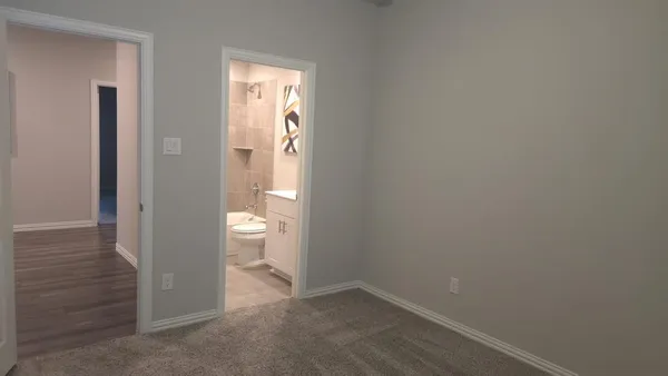 a bedroom with a bed and a couch