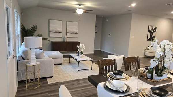 a living room with furniture and wooden floor