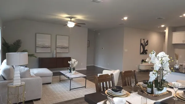 a living room with furniture a chandelier and a mirror