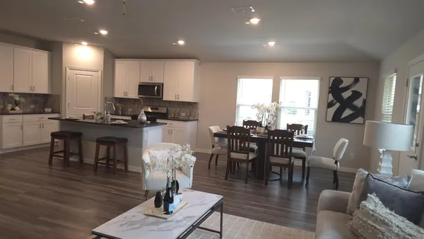 a living room with fireplace furniture and a large window